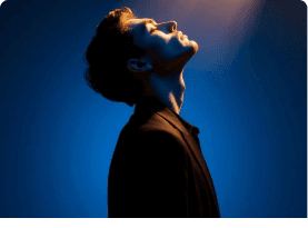 Person looking upward in blue light